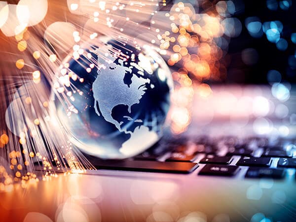 Partners Fiber Routes Features 600x450 Lighted up globe above a keyboard